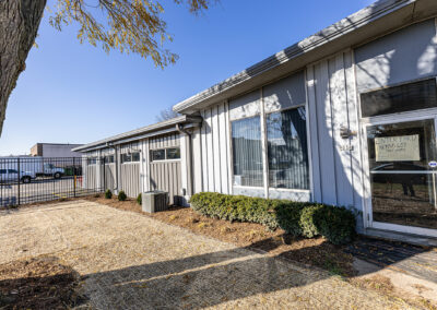 Exterior of the metal addition to the Advanced Welding Supply building featuring large picture window and door