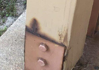 Closeup of a damaged wood beam at the Aurora West Bend facility