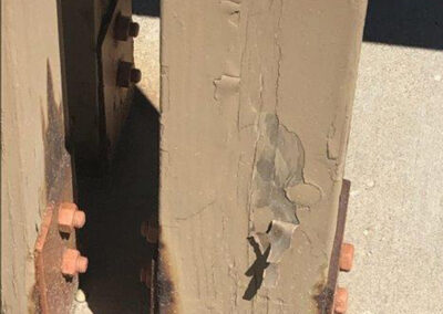 Closeup of a wood beam with peeling paint at the Aurora West Bend facility