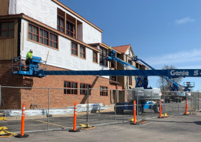 Beeler employees in lift vehicles working at the Aurora West Bend facility