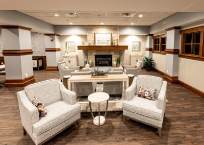 Common living space at Avalon Square featuring fireplace and an assortment of fabric chairs and end tables