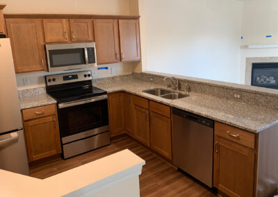 Kitchen space from Avalon Square featuring with open view of living room