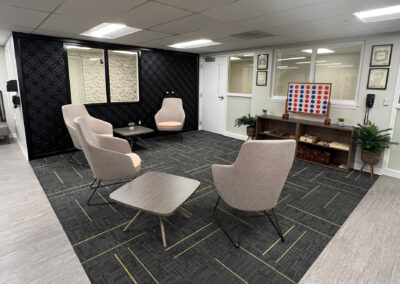 Sophisticated lounge space featuring chairs, shelving and high-end Connect Four game from Eastcastle Place senior living facility