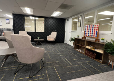 Sophisticated lounge space featuring chairs, shelving and high-end Connect Four game from Eastcastle Place senior living facility