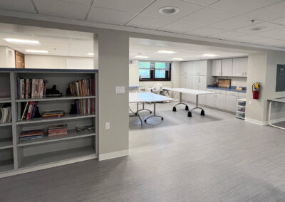 Interior common space featuring shelving, mobile tables and cabinetry from Eastcastle Place senior living facility