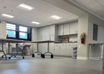 Interior common space featuring mobile tables and cabinetry from Eastcastle Place senior living facility