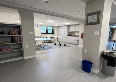 Interior common space featuring shelving, garbage can, and mobile tables from Eastcastle Place senior living facility