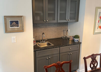 Interior space featuring dining table and side sink with shelving from Eastcastle Place senior living facility