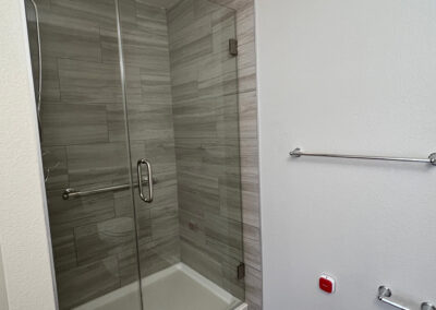 Bathroom space from Eastcastle Place senior living facility featuring towel and toilet paper rods