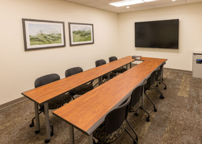 Meeting room at Froedtert West Bend featuring long tables, chairs, and TV