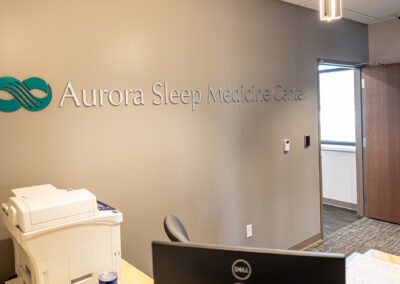 Aurora Sleep Medicine Center wall sign from a left angle viewing