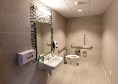 Bathroom facilities featuring the vanity, sink, and toilette at the Aurora Sheboygan Sleep Lab