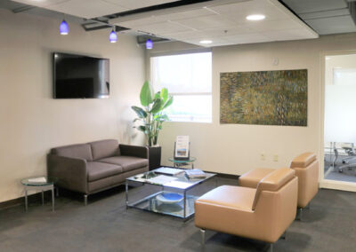 Lobby area of Komatsu building featuring two chairs, a couch and coffee table