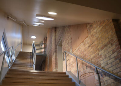 Stairwell of a Komatsu office building featuring cream city brick wall