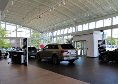 Interior lobby of the North Shore Audi car dealership featuring tan hatchback car