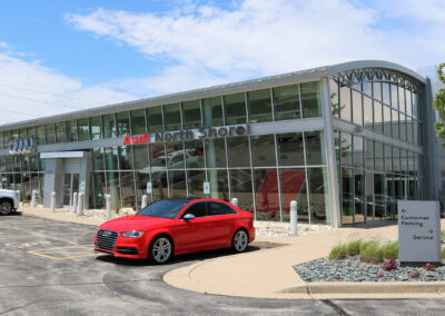 Outside of North Shore Audi with red car out front