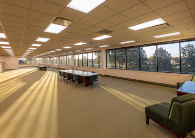 Large interior open space at Uline with two conference tables and chairs and large picture windows