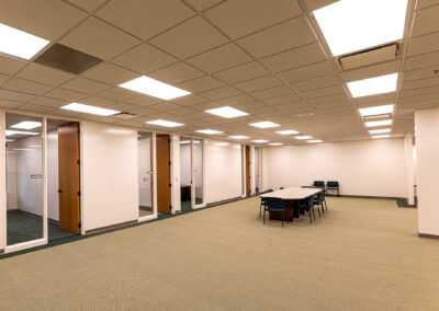 Meeting space with table and chairs outside of offices at Uline