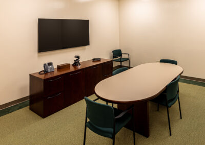 Small meeting room with a table chairs and TV at Uline