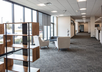 Small meeting space featuring decorative shelving, chairs, and couch at Westbrook MTE Tenant Buildout