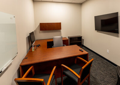 Office at Westbrook MTE Tenant Buildout featuring desk, chairs, TV, whiteboard and monitor screen