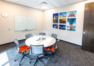 Meeting room at the Westbrook MTE Tenant Buildout featuring whiteboard, table, and chairs