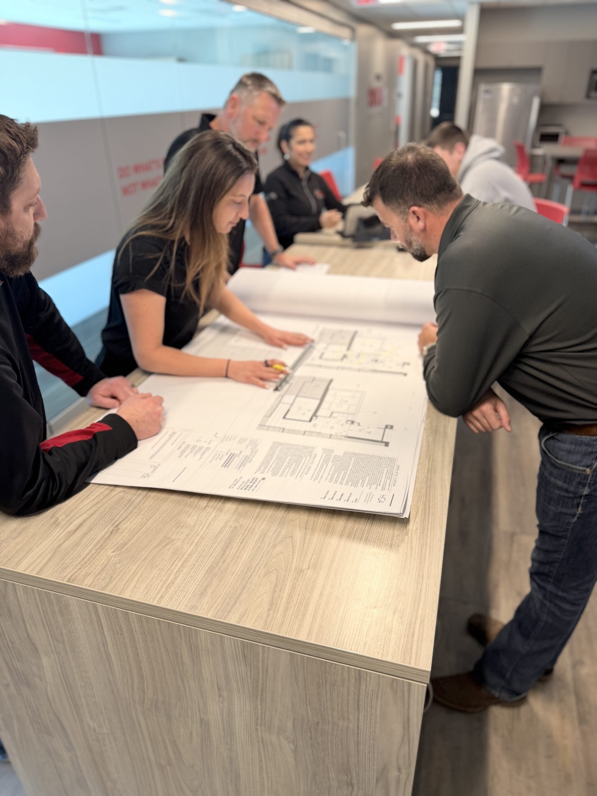 Project Team Looking At Plans