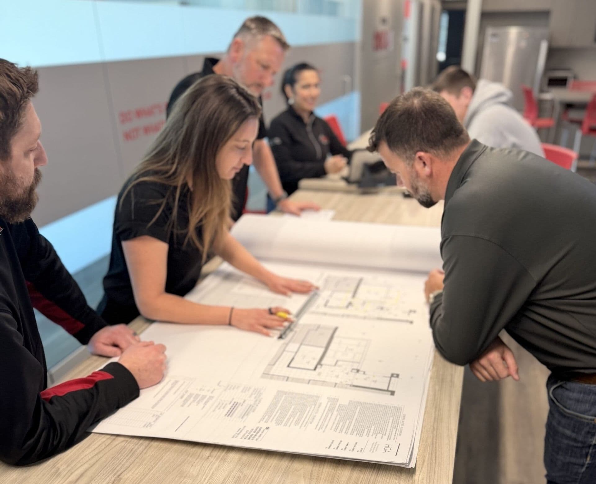 team reviewing blueprints in office